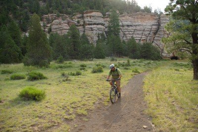 A biker pedals past the canyon walls.